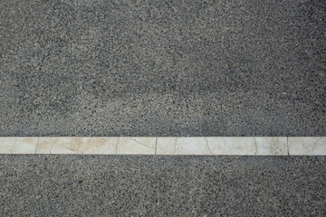 Fototapeta premium white strip of road markings on a new road, close-up photo