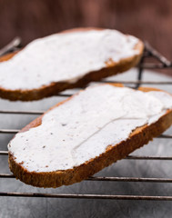 Cottage cheese on Rye bread slices on a rack