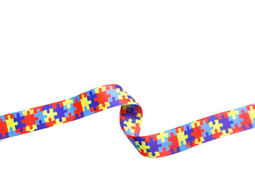 World Autism awareness and pride day with Puzzle pattern ribbon isolated on white