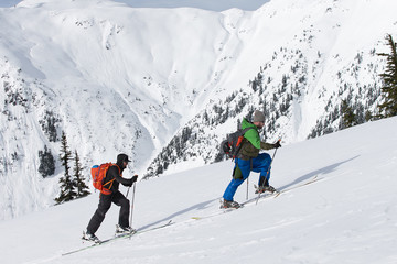 Fototapeta na wymiar Young men ski touring in the mountains