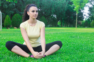 Stretching sportswoman in park