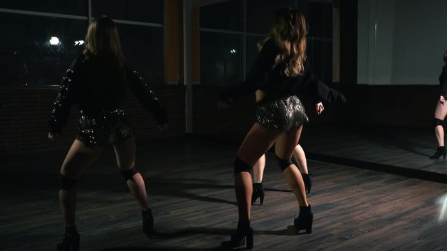 young sexy girls in shorts are dancing twerk in the dance studio