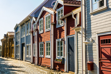 Row of typical wooden swedish houses on little town street