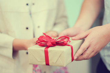 close up man hand and woman (couple) holding gift box together for give to someone in special day concept