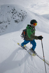 Young man ski touring in the mountains