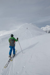Fototapeta na wymiar Young man ski touring in the mountains