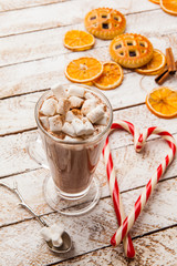 Hot cocoa with marshmallow on white rustic background. Top view