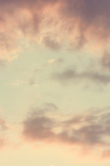 The vertical view of sky background or texture at the sunset time with clouds. Copy space