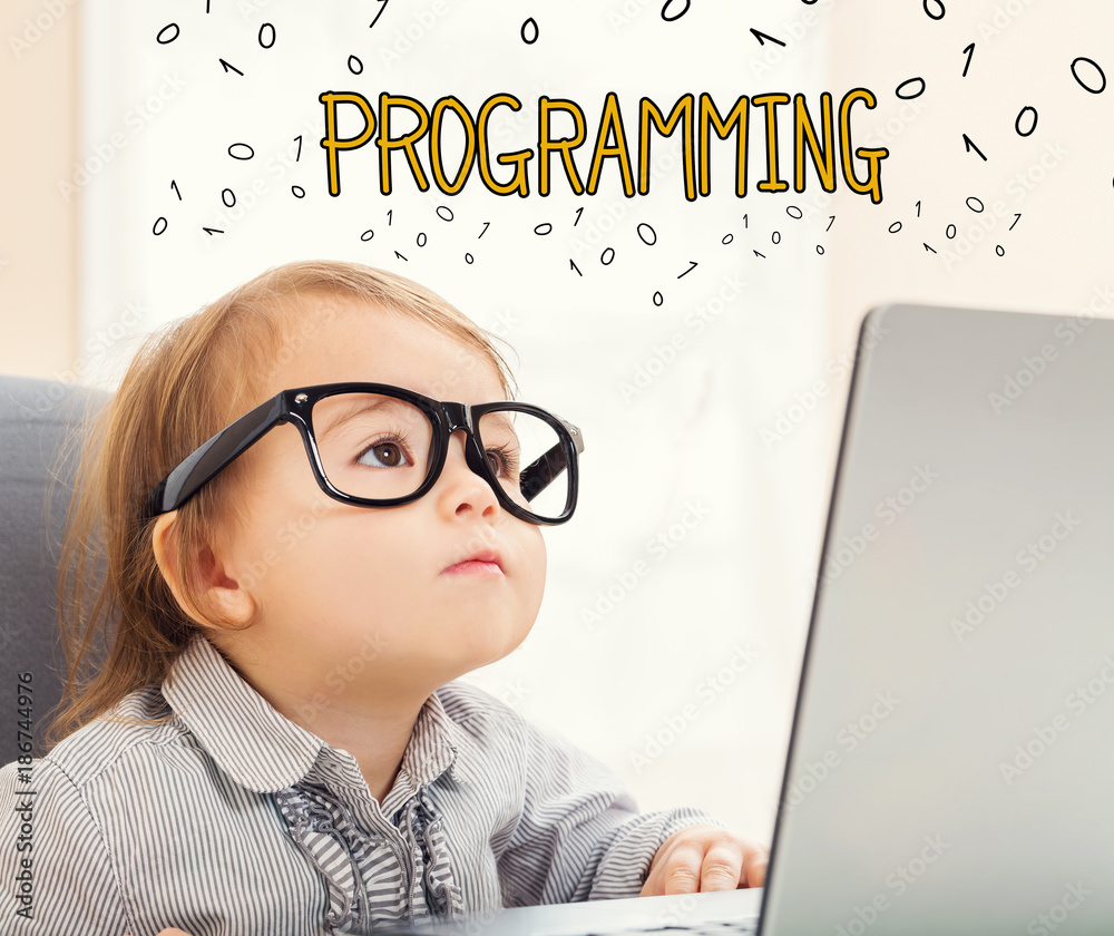 Wall mural programming text with toddler girl using her laptop