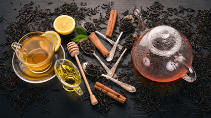 Black and green tea with lemon, honey, cinnamon and ginger. Hot drink Top view. Copy space.