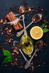 Assortment of dry teas and fragrant herbs and spices. On a wooden background. Top view. Copy space.