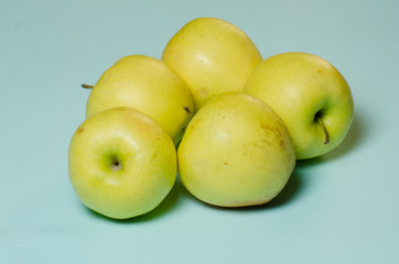 green apple lies on a turquoise background