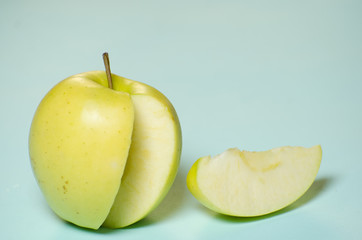green apple lies on a turquoise background