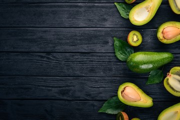 Avocado and kiwi on a wooden background. Top view. Free space for your text.