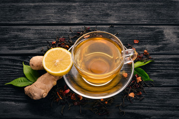 Tea with lemon and ginger. Hot drink On a wooden background. Top view. Copy space.