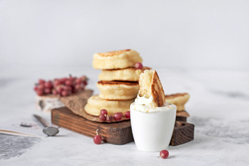 Pancakes with berries and sour cream