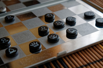Photo with a picture of a chess steel Board and chess pieces, Metal chess pieces on a chess Board with reflection