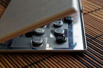 Photo with a picture of a chess steel Board and chess pieces, Metal chess pieces on a chess Board with reflection