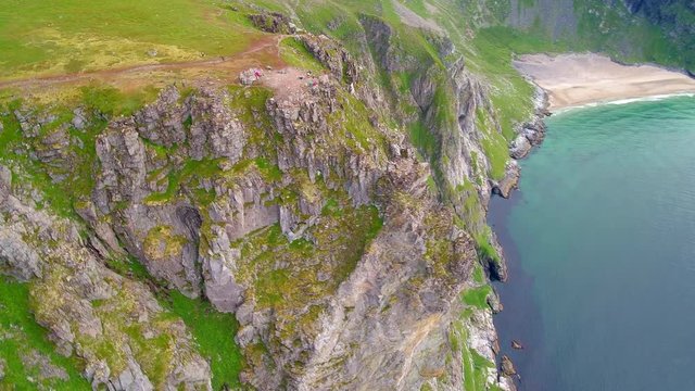 Pan right aerial, cliffs on Lofoten Island