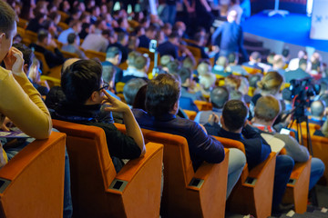 People attend business conference in the congress hall