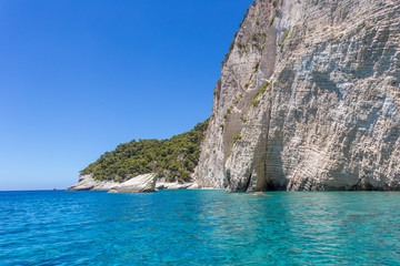 Blue sea and rocks on sunny day in Greece.