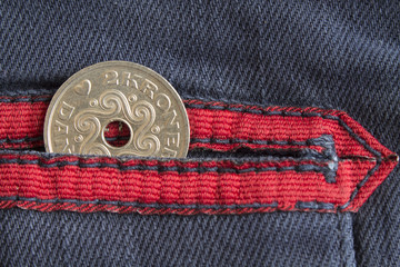 Denmark coin denomination is 2 krone (crown) in the pocket of worn blue denim jeans with red stripe