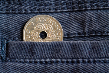Denmark coin denomination is 2 krone (crown) in the pocket of dark blue denim jeans