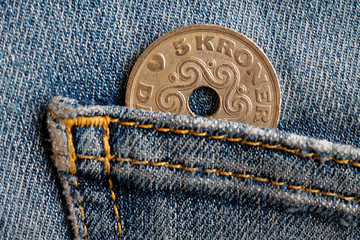 Denmark coin denomination is five krone (crown) in the pocket of blue worn denim jeans