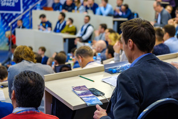 Fototapeta na wymiar People attend business conference in the congress hall