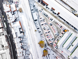 Aerial view of snow covered rail and road networks. Snow, ice and winter weather conditions close railway links and shut roads causing transport delays and dangerous conditions.