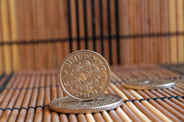 Denmark coins denomination is 5, 2 and 1 krone (crown) lie on wooden bamboo table, good for background or postcard