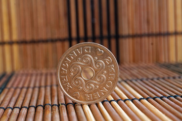 Denmark coin denomination is 2 krone (crown) lie on wooden bamboo table, good for background or postcard
