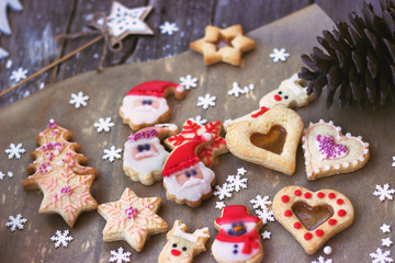Royal icing decorated christmas cookies on  on wooden background;