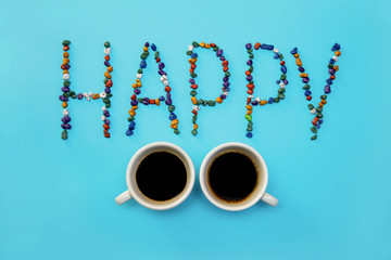 pebbles chocolate ceramic cup coffee espresso bright blue background top view two words letters happy white