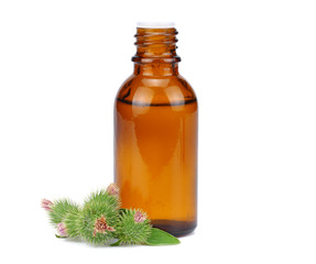 bottle with burdock (castor, agrimony) oil isolated on white background