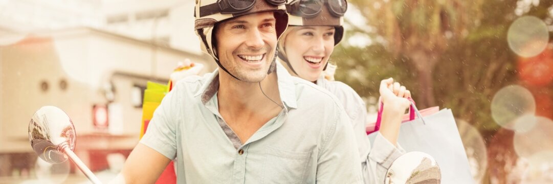 Hip Young Couple Riding Scooter With Shopping Bags