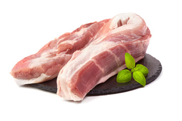 Fresh pork tenderloin on stone plate, isolated on white background.