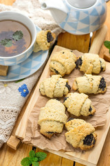 Sweet shortcrust pastry rolls  croissants with poppy seeds and tea