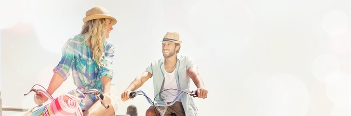 Couple on bike ride by the beach