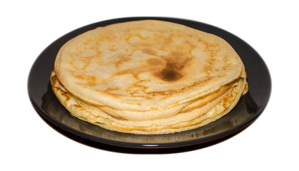 pancakes on a dark plate on a white background