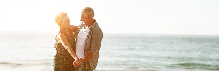Senior couple dancing at the beach