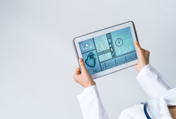 Close of female doctor hands working with tablet pc computer