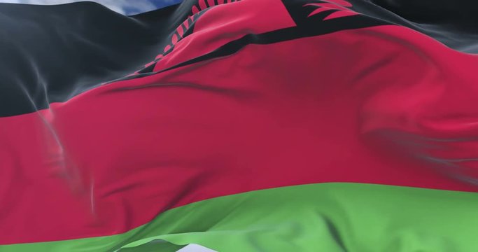 Flag of Malawi waving at wind with blue sky in slow, loop