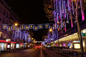 Paris, France - December 4, 2017: Christmas lights on Haussmann boulevard and Parisian department...