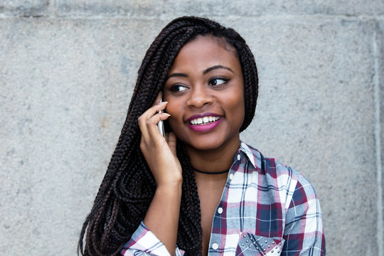 Beautiful african woman flirting at phone