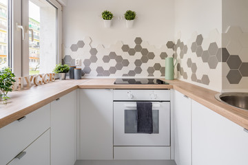 White kitchen with hexagonal tiles
