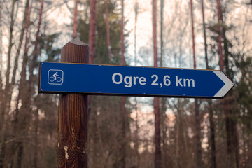 Sign in forest. Signpost - bicycle path on the ogre