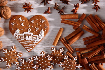 Star and heart made of sweet gingerbread dipped in white icing is a great decoration at the Christmas table.
