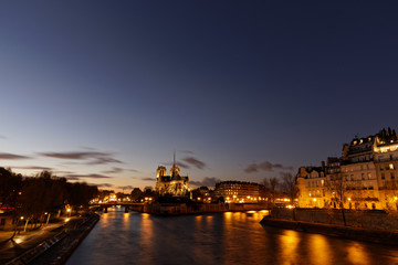 Fototapeta na wymiar Notre dame de Paris by night and the seine river in the city of Paris in france