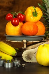 Old cast iron kitchen scale with fruit and vegetables. Healthy eating. Selling fruit.